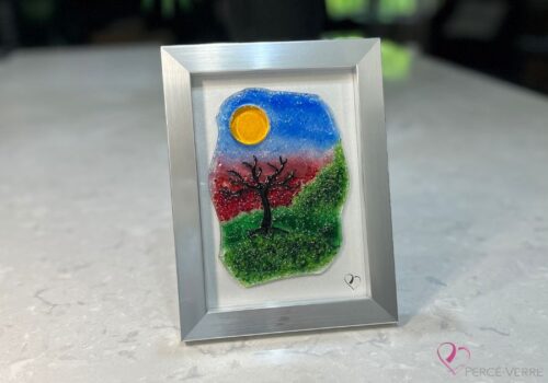 Work in fused glass representing a delicately carved tree, integrated into a colored or abstract background. Arbre No. 1 - Created by Stéphanie Béland - Percé-Verre.