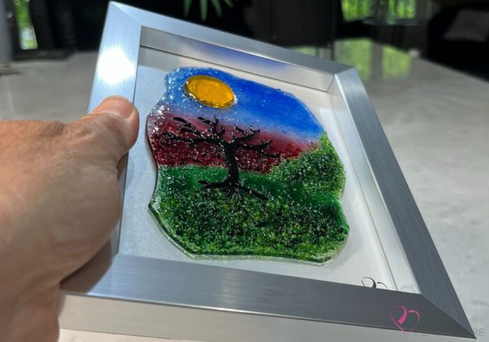 Work in fused glass representing a delicately carved tree, integrated into a colored or abstract background. Arbre No. 1 - Created by Stéphanie Béland - Percé-Verre.