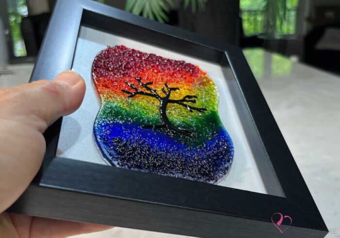 Work in fused glass representing a delicately carved tree, integrated into a colored or abstract background. Arbre No. 2 - Created by Stéphanie Béland - Percé-Verre.