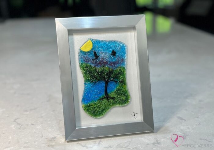 Work in fused glass representing a delicately carved tree, integrated into a colored or abstract background. Arbre No. 4 - Created by Stéphanie Béland - Percé-Verre.
