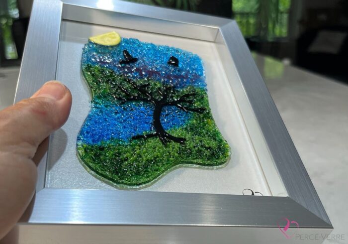 Work in fused glass representing a delicately carved tree, integrated into a colored or abstract background. Arbre No. 4 - Created by Stéphanie Béland - Percé-Verre.