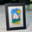 Voilier No. 3 Fused glass work depicting a sailboat on the sea, framed 5 x 7. Cap sur les rêves collection, signed Percé-Verre.