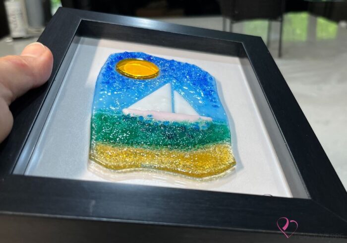 Voilier No. 5 Fused glass work depicting a sailboat on the sea, framed 5 x 7. Cap sur les rêves collection, signed Percé-Verre.