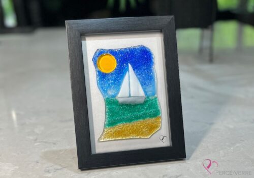 Voilier No. 6 Fused glass work depicting a sailboat on the sea, framed 5 x 7. Cap sur les rêves collection, signed Percé-Verre.