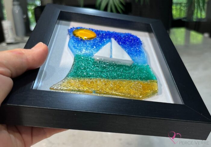 Voilier No. 6 Fused glass work depicting a sailboat on the sea, framed 5 x 7. Cap sur les rêves collection, signed Percé-Verre.