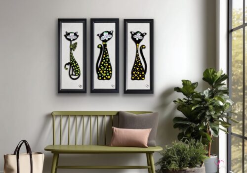 Mural artworks featuring the cats Limonade, Citron, and Limette, created using fused glass and displayed in an interior setting.